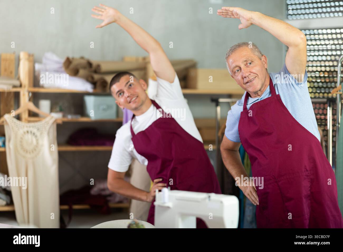Male tailors doing a warm-up at work Stock Photo