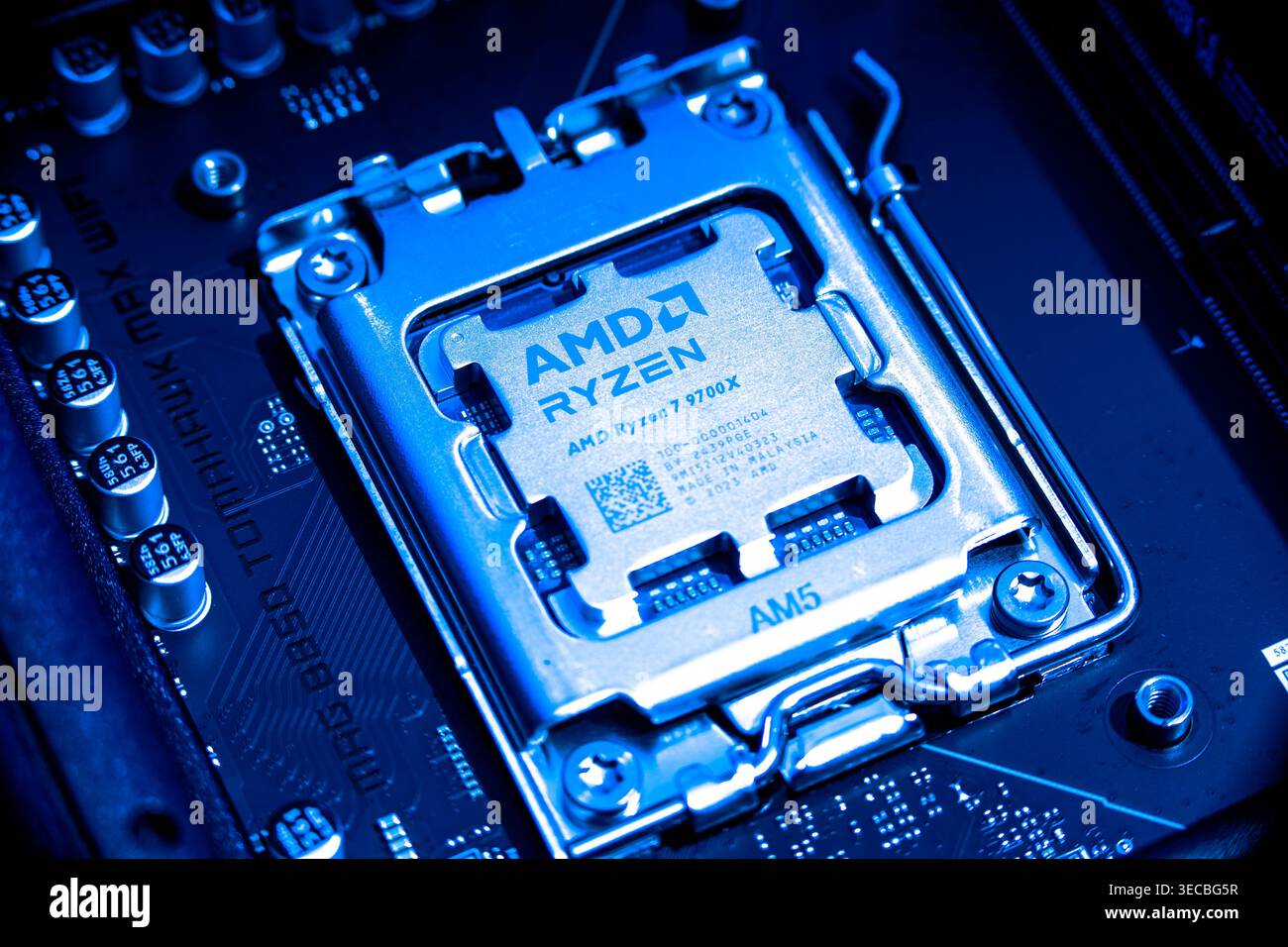 AMD Ryzen 7900x Processor Chip Installed In Cpu Socket On Computer Motherboard Stock Photo