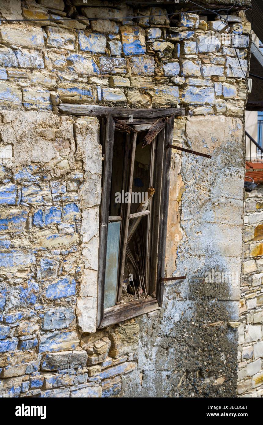 Old Broken Window in Weathered Stone Wall Stock Photo