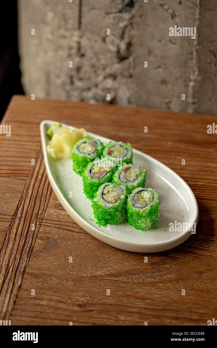 Sushi rolls with green coating and ginger Stock Photo