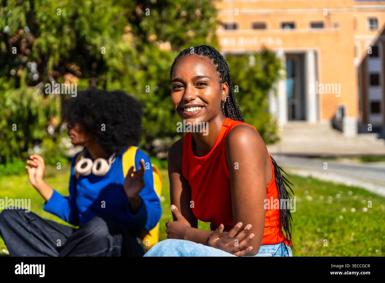 Happy students sharing a laugh on university campus Stock Photo