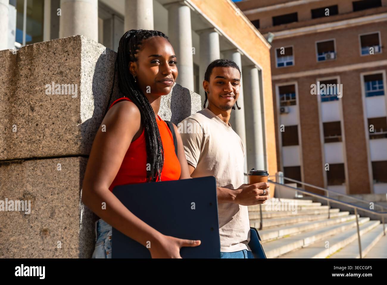 University students standing on campus building stairs Stock Photo