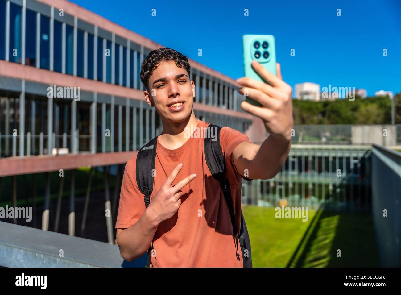 Young student taking selfie with smartphone on campus Stock Photo
