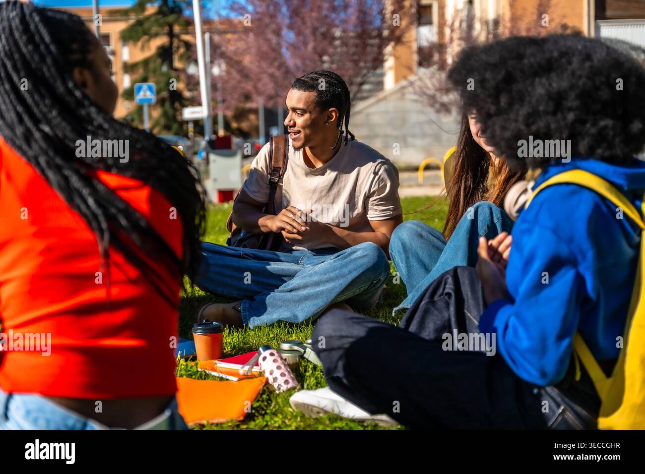 Diverse students talking and sharing moments on university campus Stock Photo