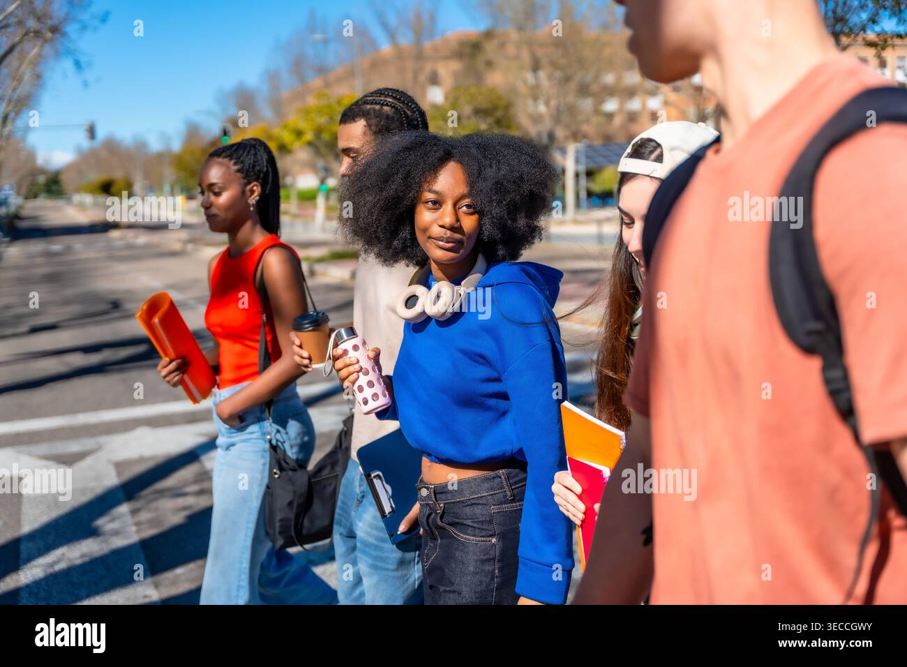 Diverse university students walking together on campus Stock Photo