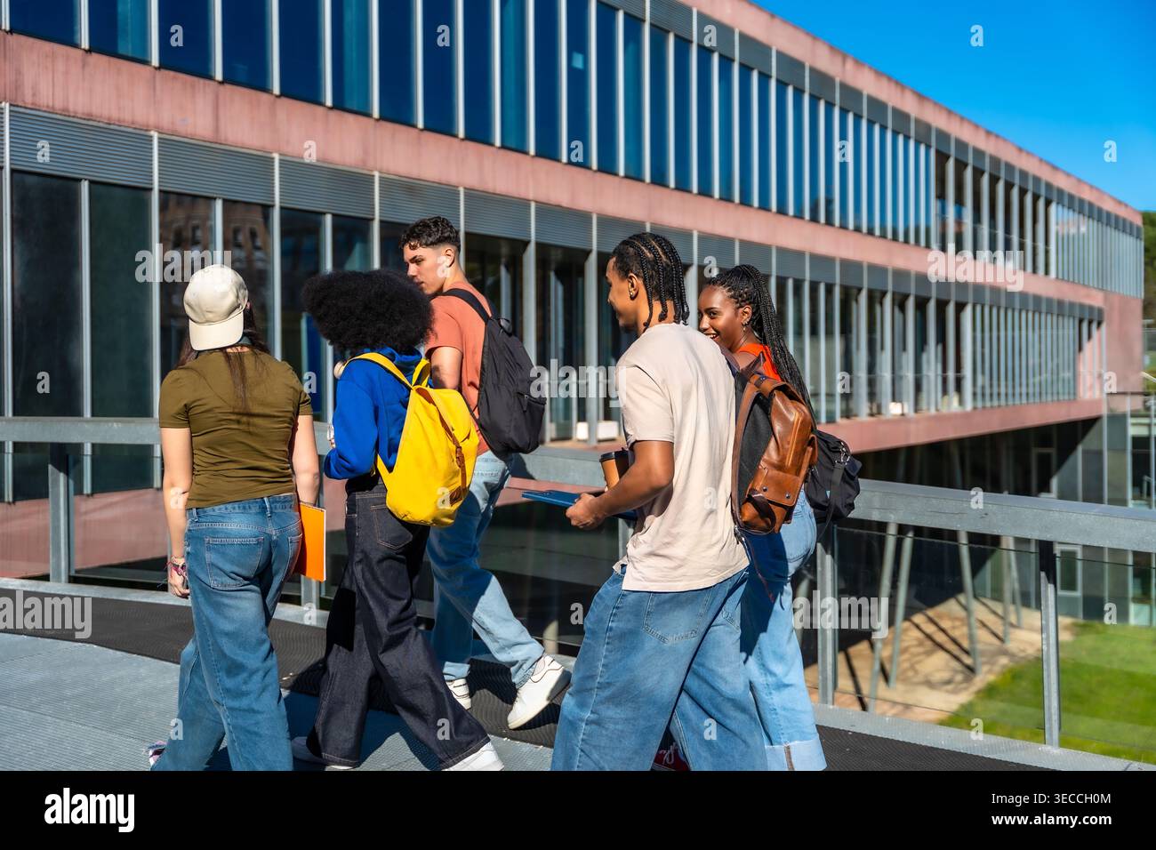 Diverse students walking on university campus, learning and collaborating Stock Photo