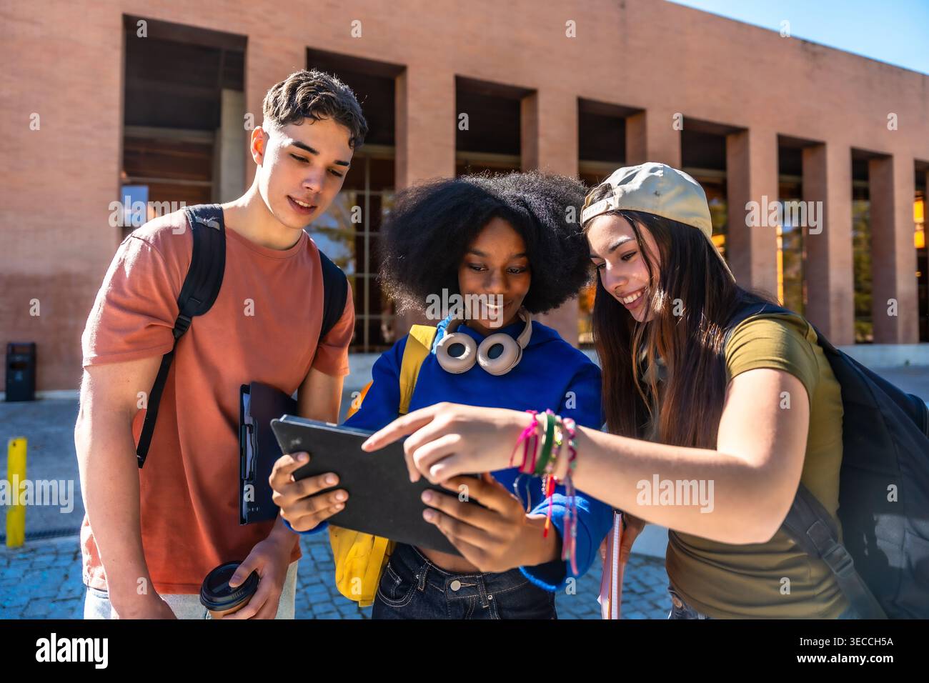 Group of diverse students using tablet on campus Stock Photo