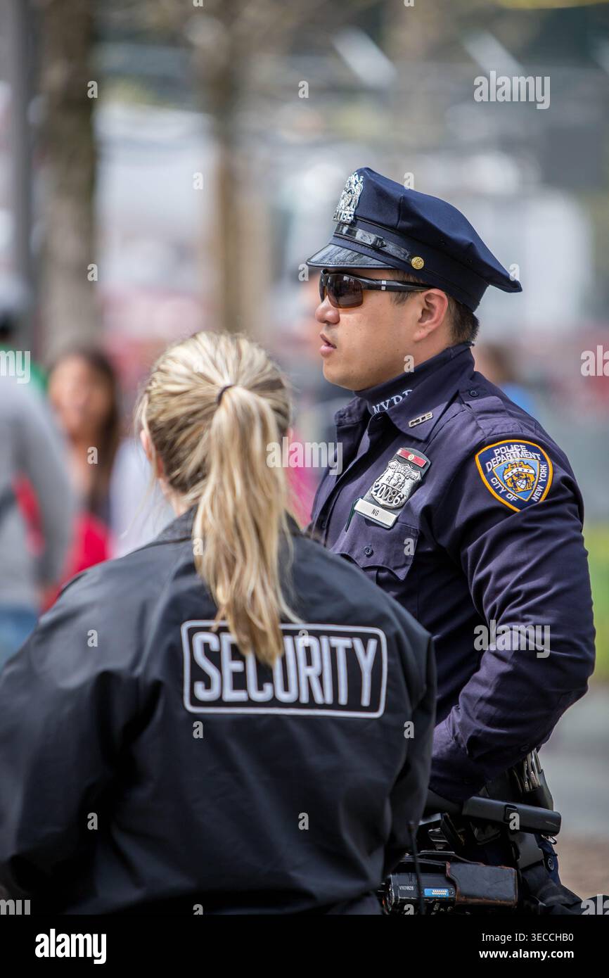 An NYPD officer and a private security guard stand together on duty ...