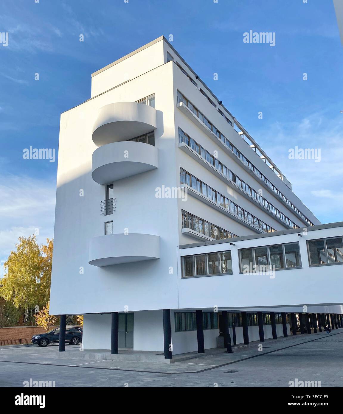 Moscow, Russia- October 9 2021: Modern white building with geometric balconies under blue sky, urban architecture, clean daylight exterior scene moder Stock Photo