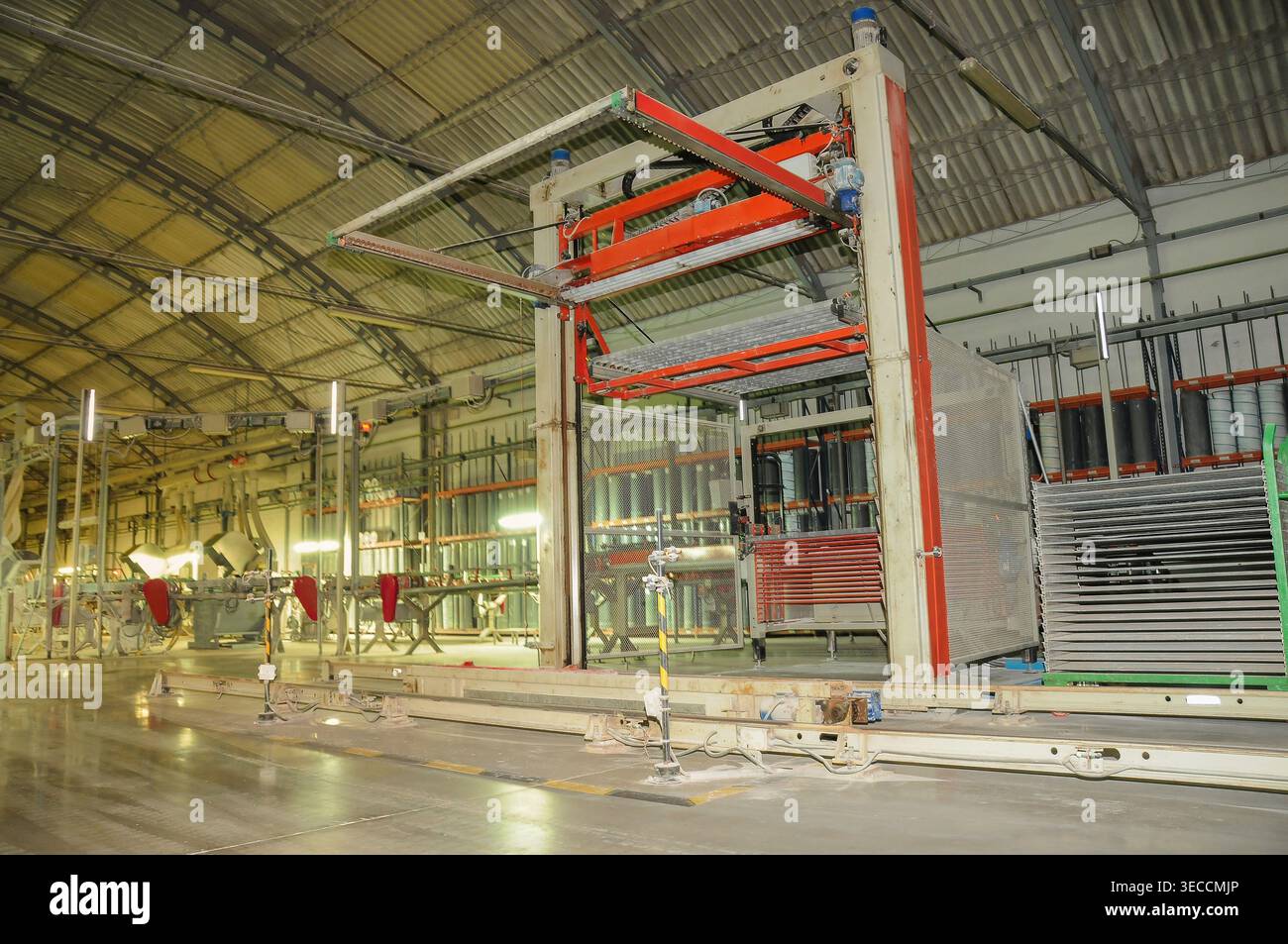 Industrial machine lifts and processes ceramic tiles along a production ...