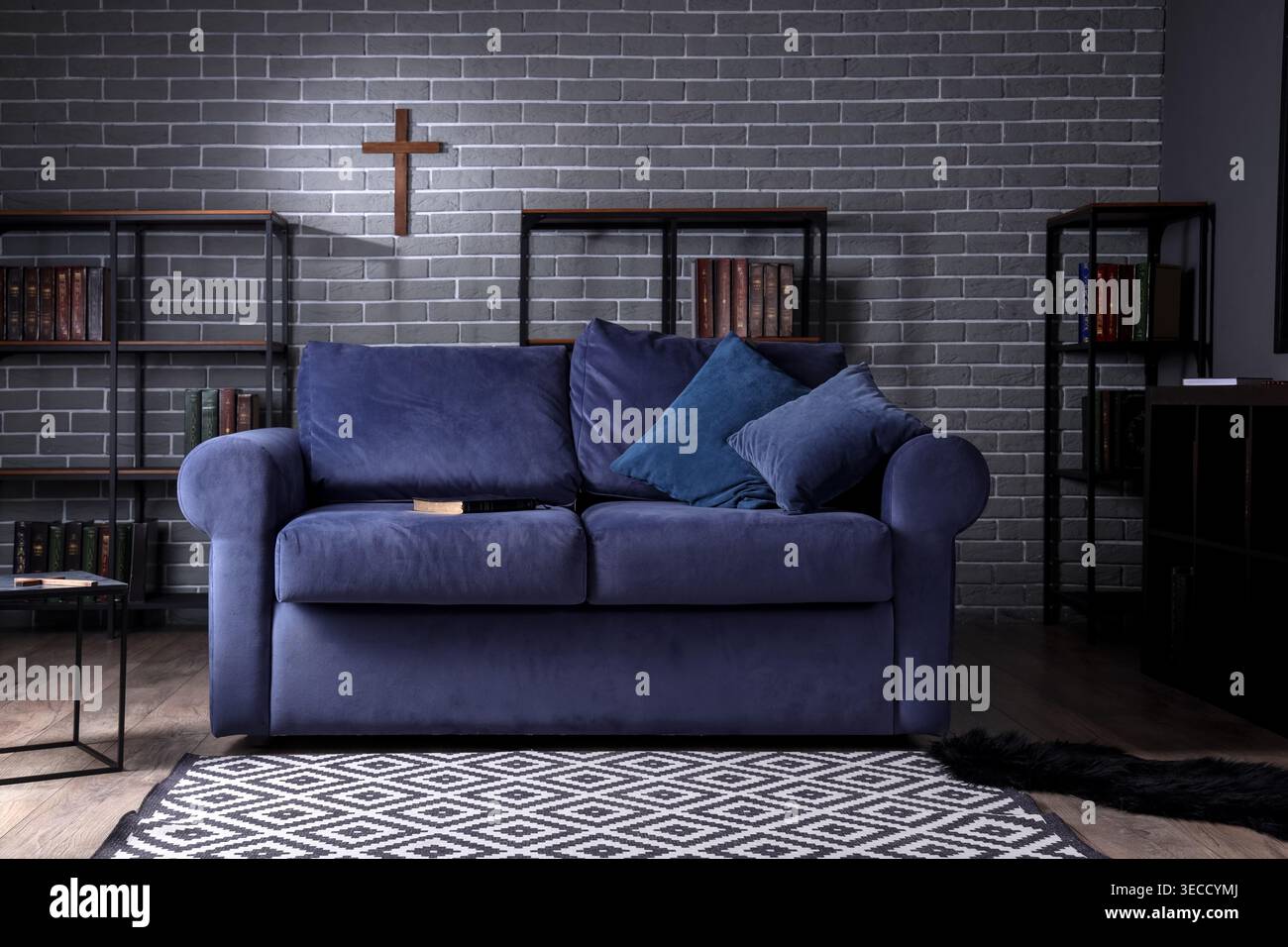 Interior of living room with Holy Bible on sofa and bookshelves Stock ...