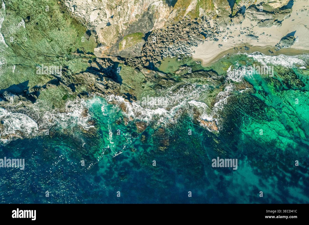 Dynamic ocean waves featuring brilliant blue and green hues meet a ...