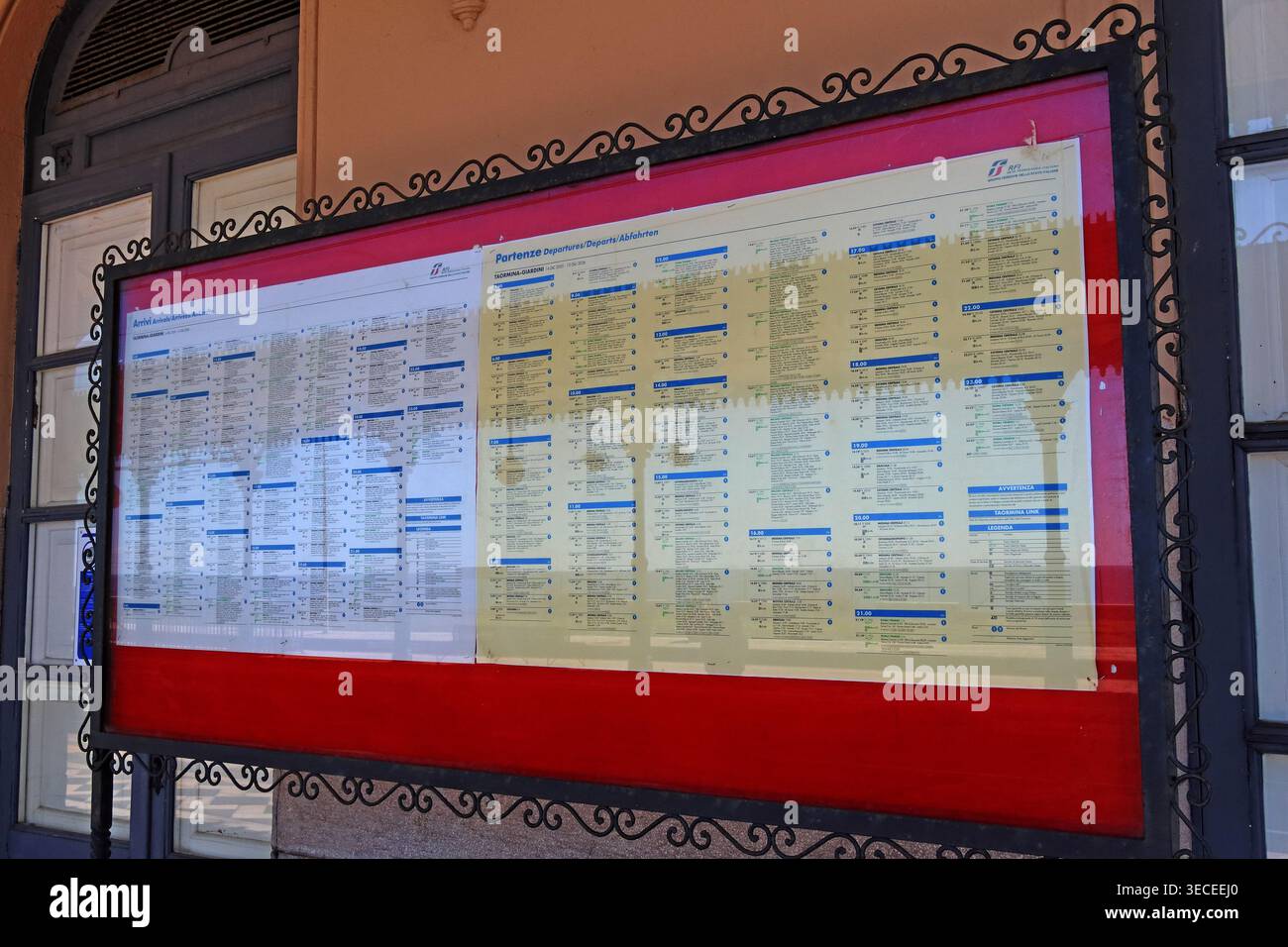 Trenitalia timetable on station, Taormina-Giardini, NE Sicily, Italy Stock Photo
