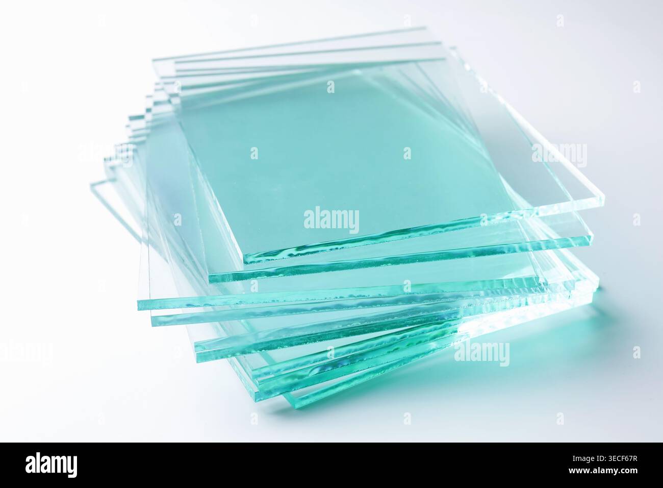Stack of glass sheets on light background, closeup Stock Photo