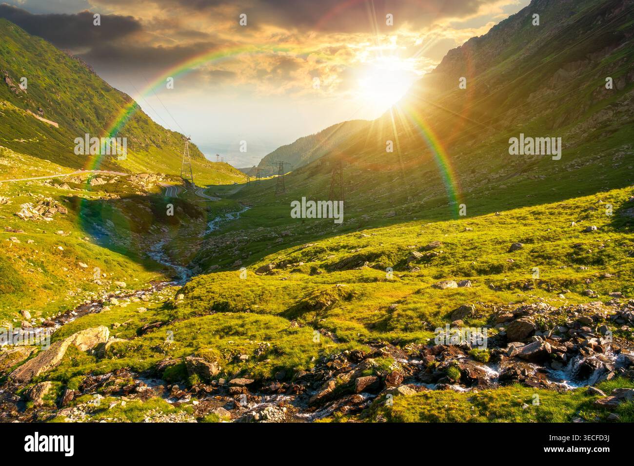 sunset over road through mountains winding uphill. popular highway travel destination of Romania. nice view of mountain on summertime weather. road jo Stock Photo