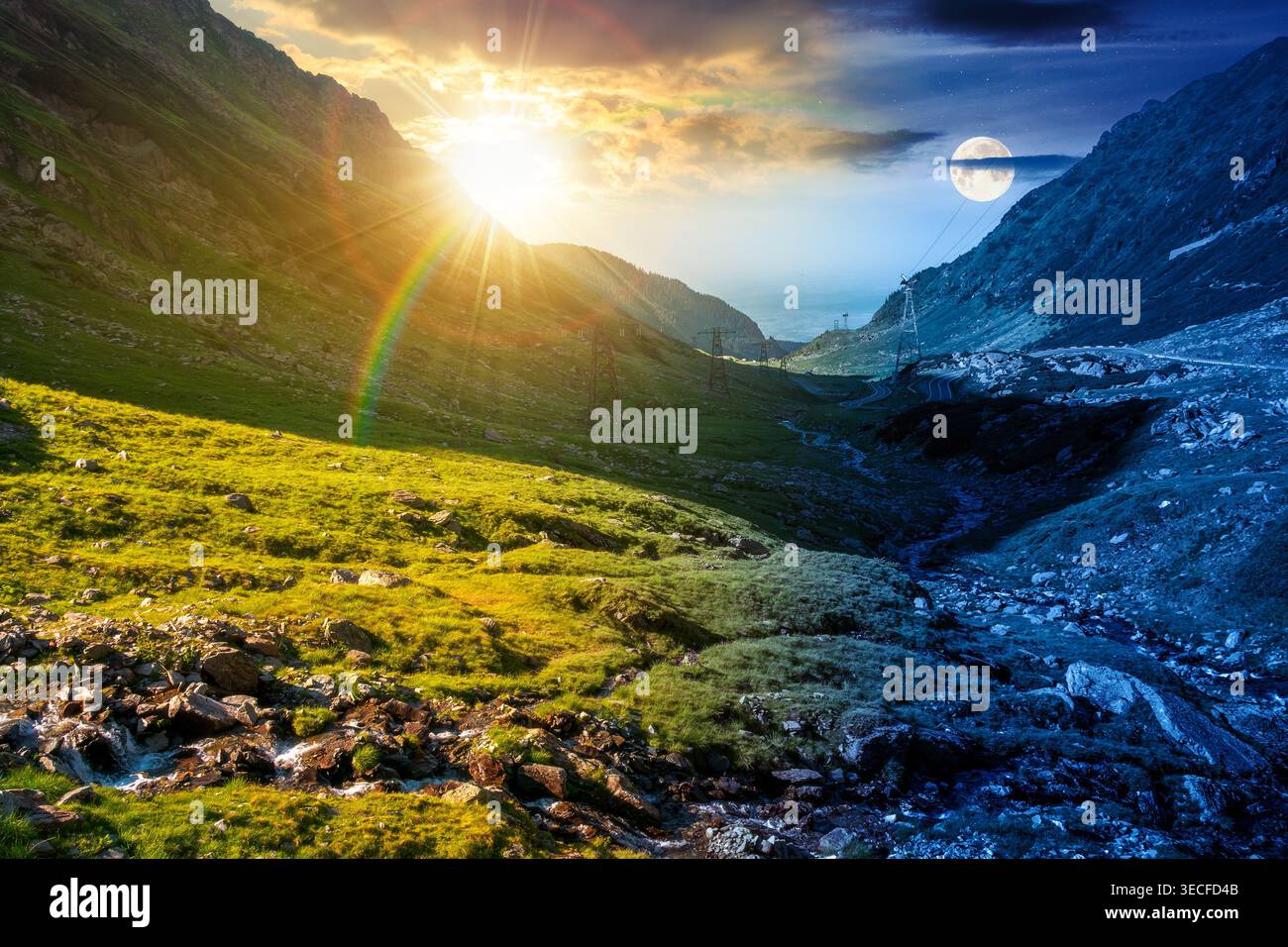 day meet night. road through mountains winding uphill. sun and moon over popular highway travel destination. epic view of mountain on summer solstice Stock Photo
