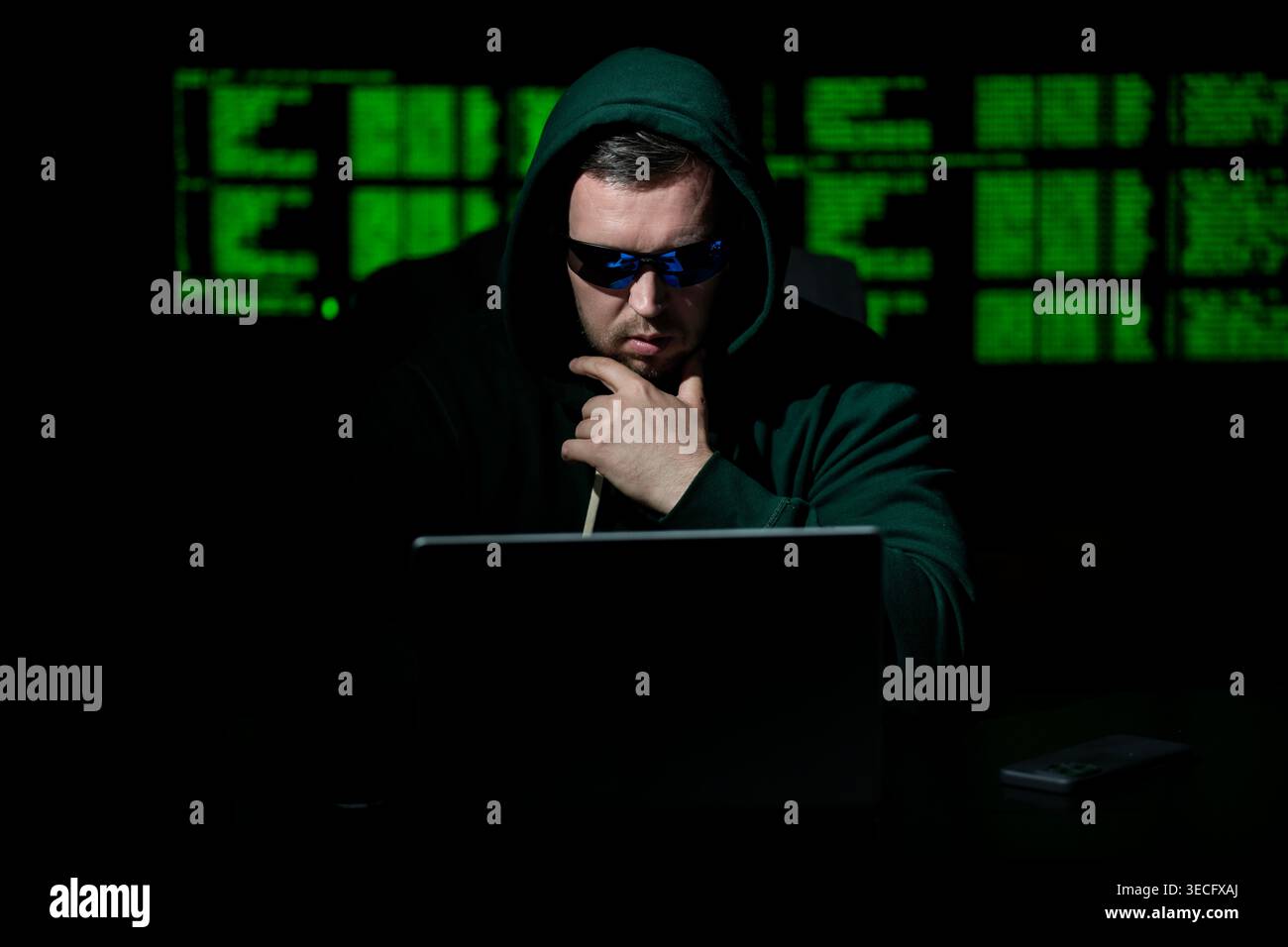 Hacking programmer uses laptop computer. Hacking programmer writes code at night. Hacking programmer monitors server system. Hacking programmer Stock Photo