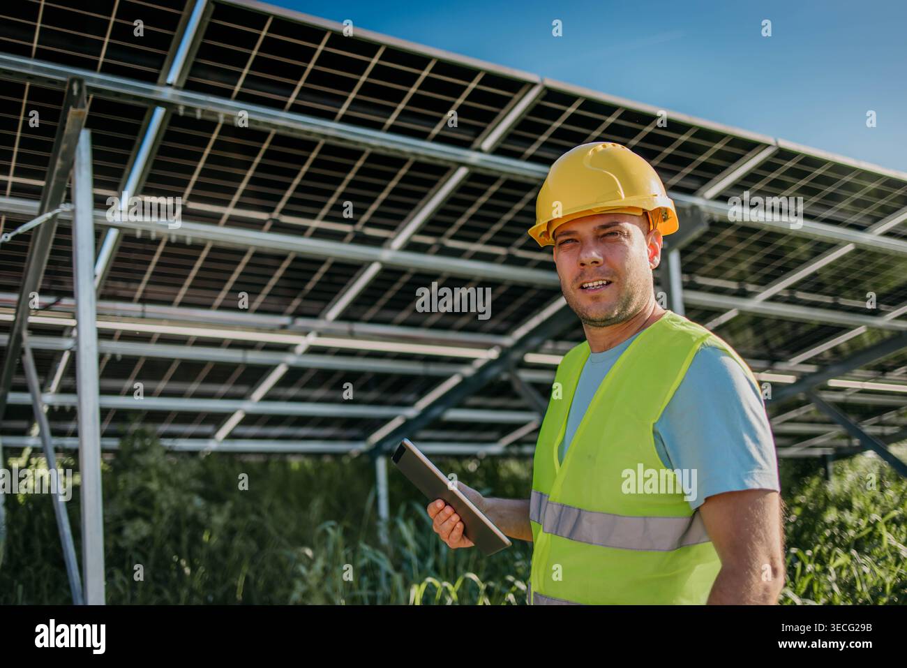 Man is working with solar panels outdoors at daytime Stock Photo