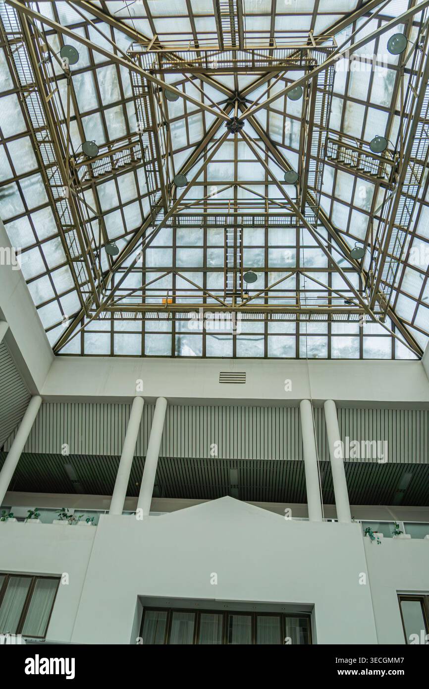 Spacious, white-walled atrium with high ceilings, skylight, exposed ...