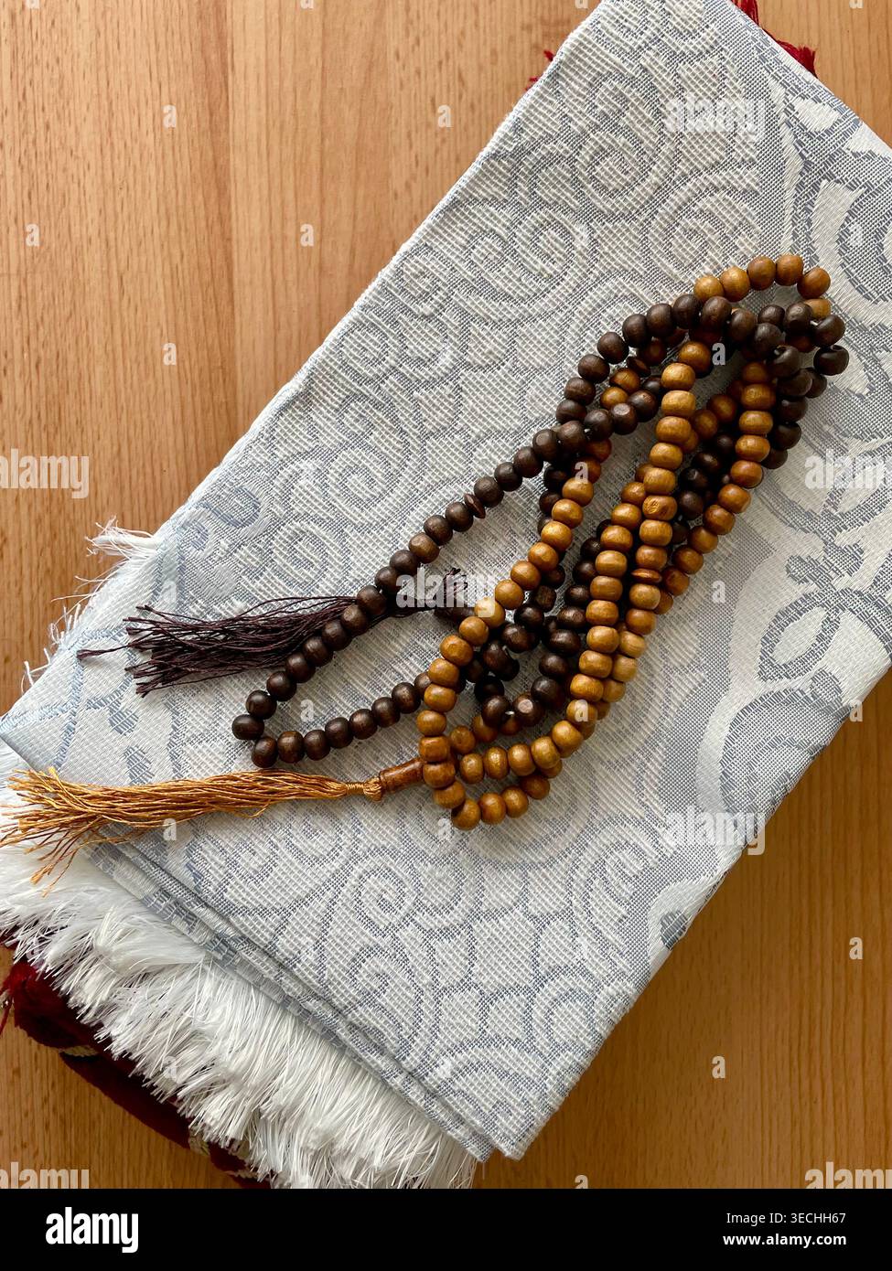Brown prayer beads on a praying mat Stock Photo
