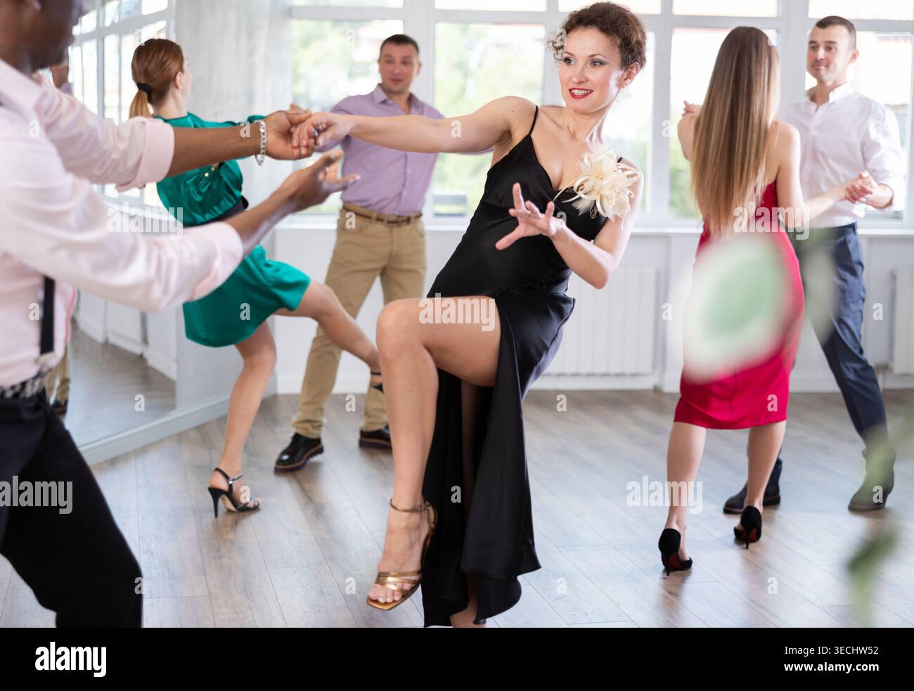 Man and woman practicing swing dance in dancing studio Stock Photo