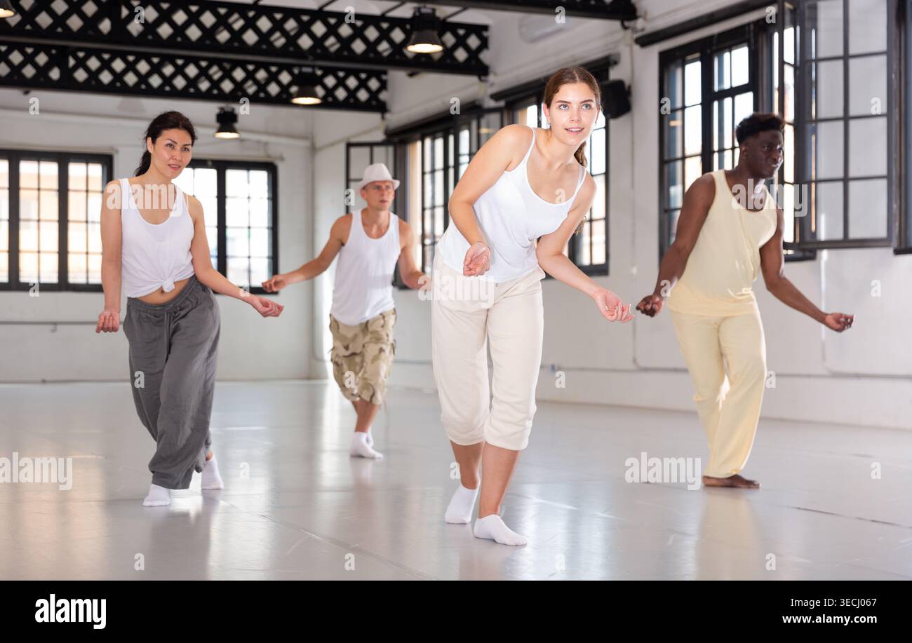 Four dancers exercising swing movements Stock Photo