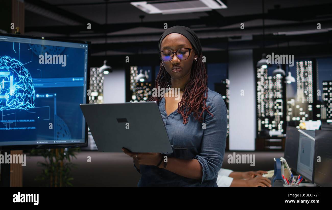 Programmer in office developing complex machine learning algorithms simulating human brain thought processes. IT professional deploys AI tools, performing software quality assurance Stock Photo
