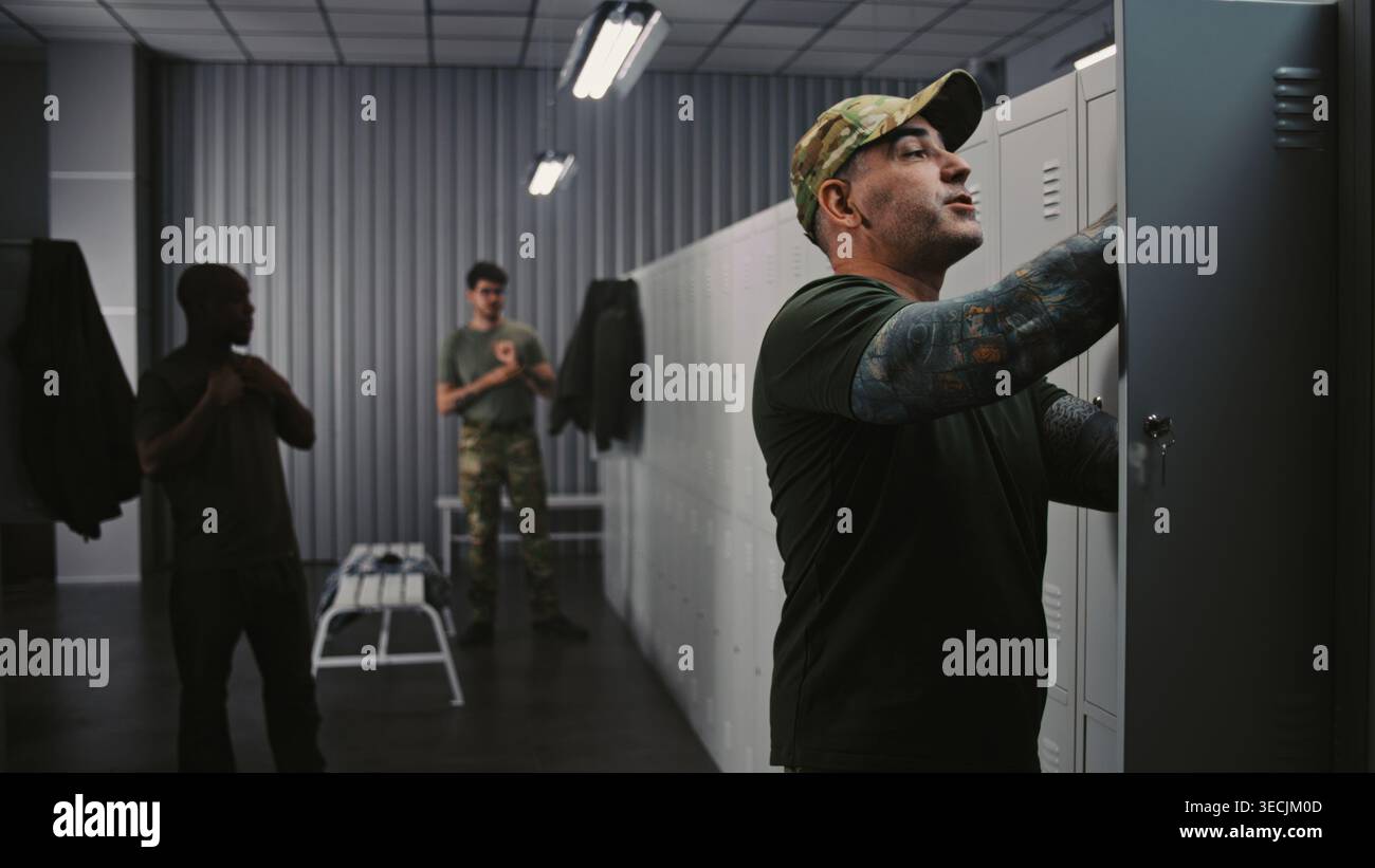 Three Diverse Military Officers Prepare For Training in Base Locker ...