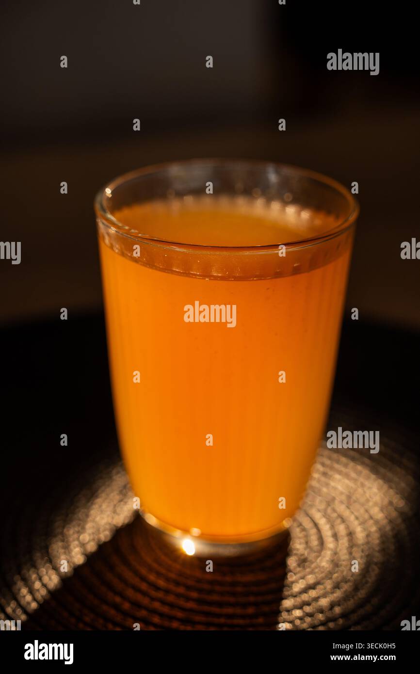 Fruit compote in glass on dark coaster and dark background Stock Photo