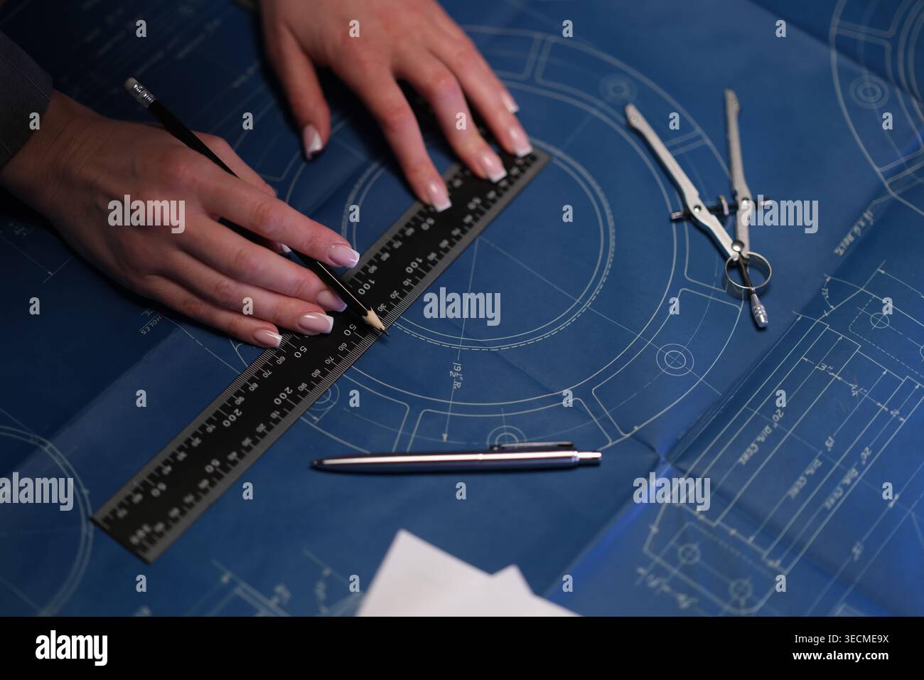 Professional draftsman creating precise architectural blueprints Stock Photo