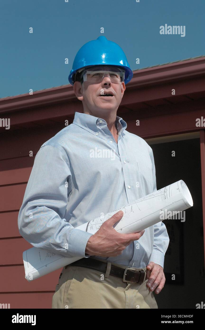 Engineering contactor supervisor with blueprints plans, USA Stock Photo