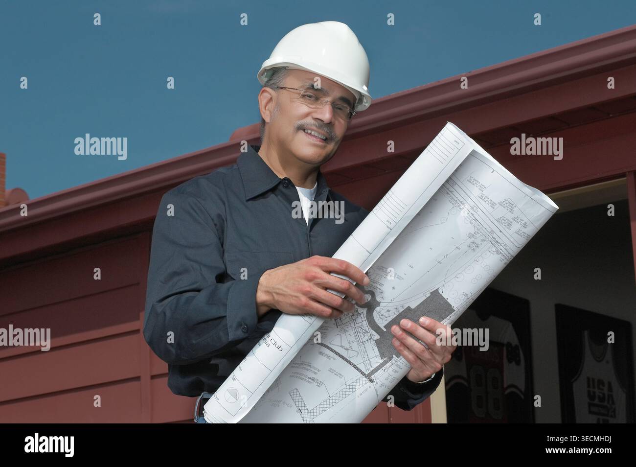 Engineering contactor supervisor with blueprints plans, USA Stock Photo