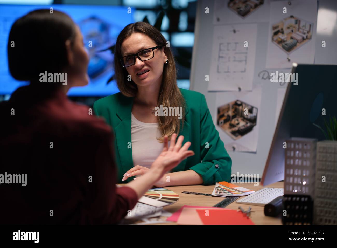 Engaging interior design discussion between two professionals in a creative workspace Stock Photo