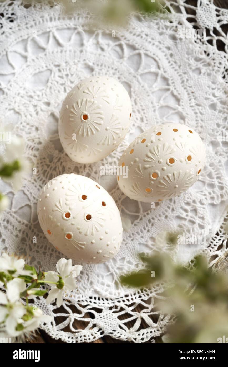 Three white Easter eggs decorated with wax, top view Stock Photo