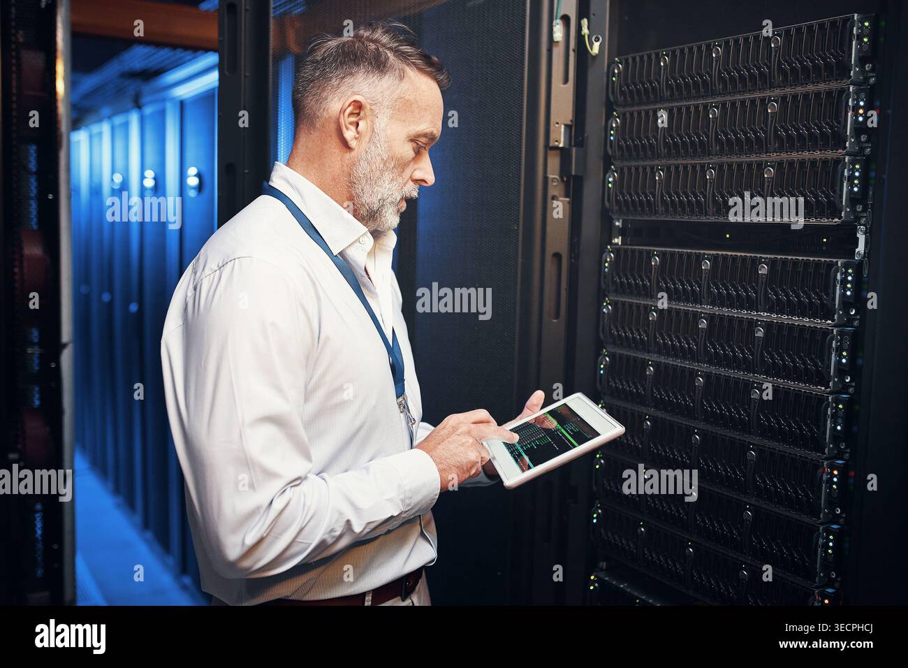 Tablet, man and engineer in data center with inspection, research or programming on app. Cybersecurity, database and mature technician in server room Stock Photo