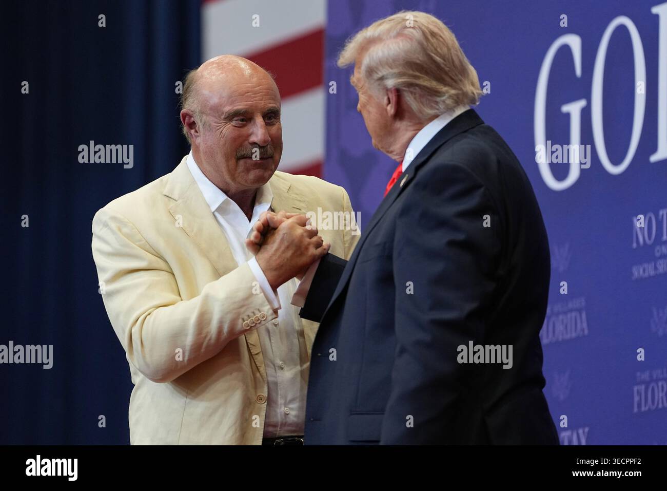 Dr. Phil McGraw greets President Donald Trump lduring an event at a ...