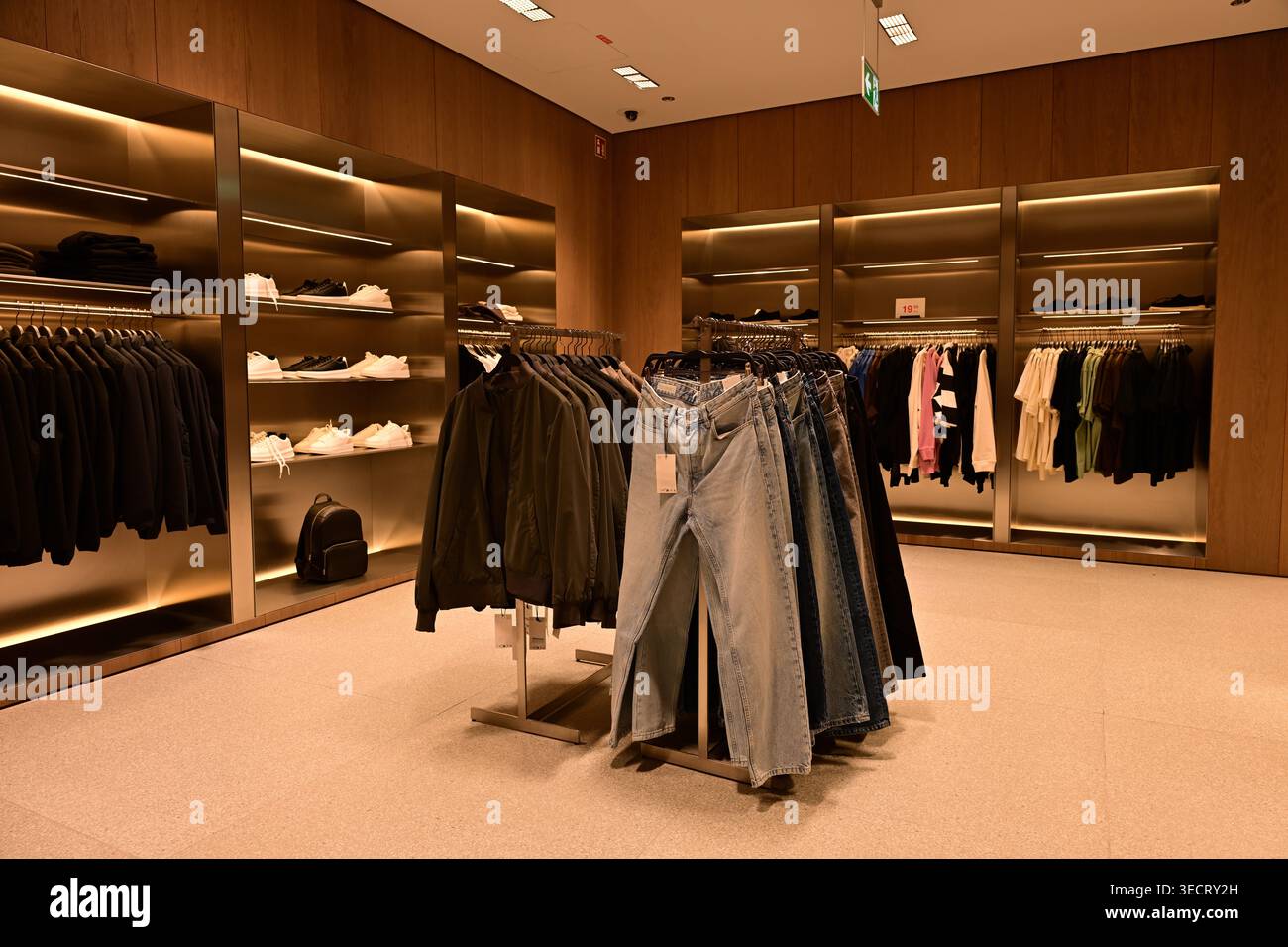 Modern clothing store interior with jeans rack and sneakers Stock Photo