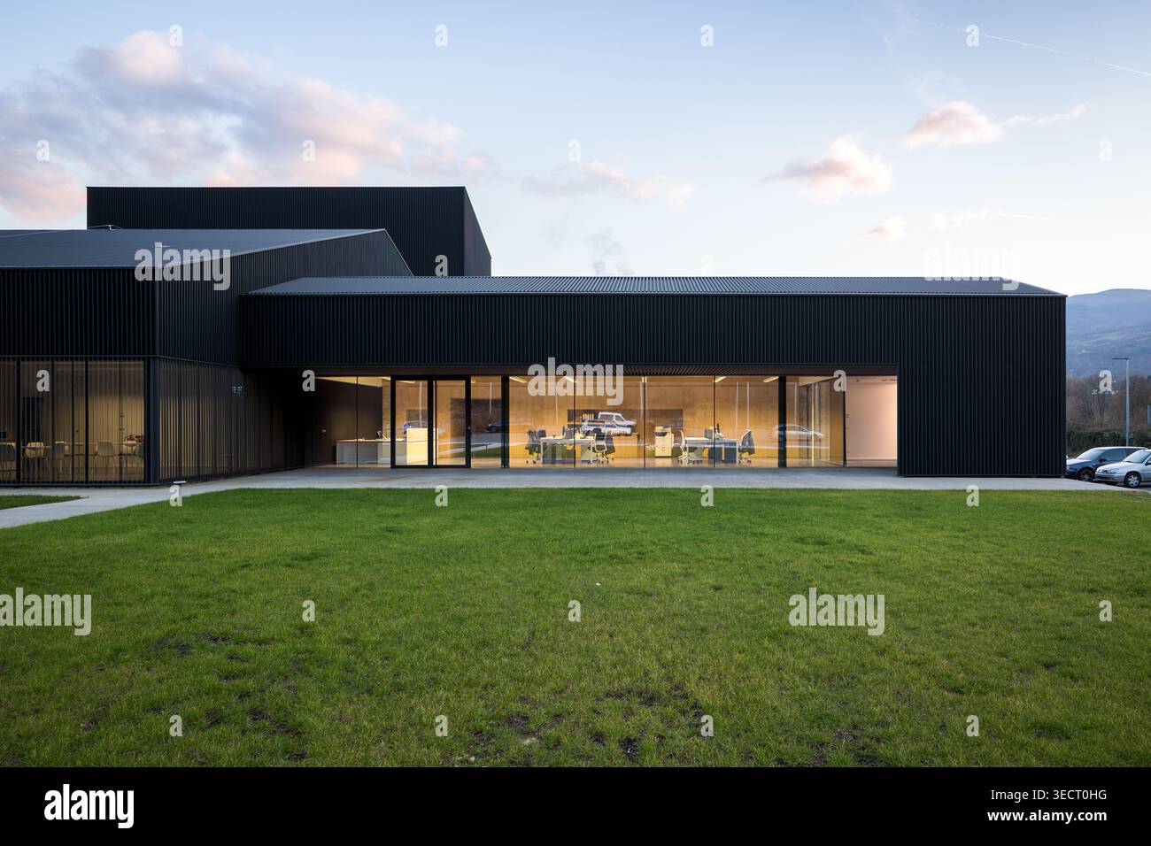 Contemporary candy factory building with dark metal cladding and wide ...