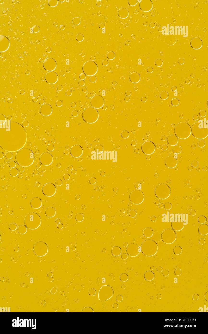 Golden liquid with bubbles abstract macro background Stock Photo