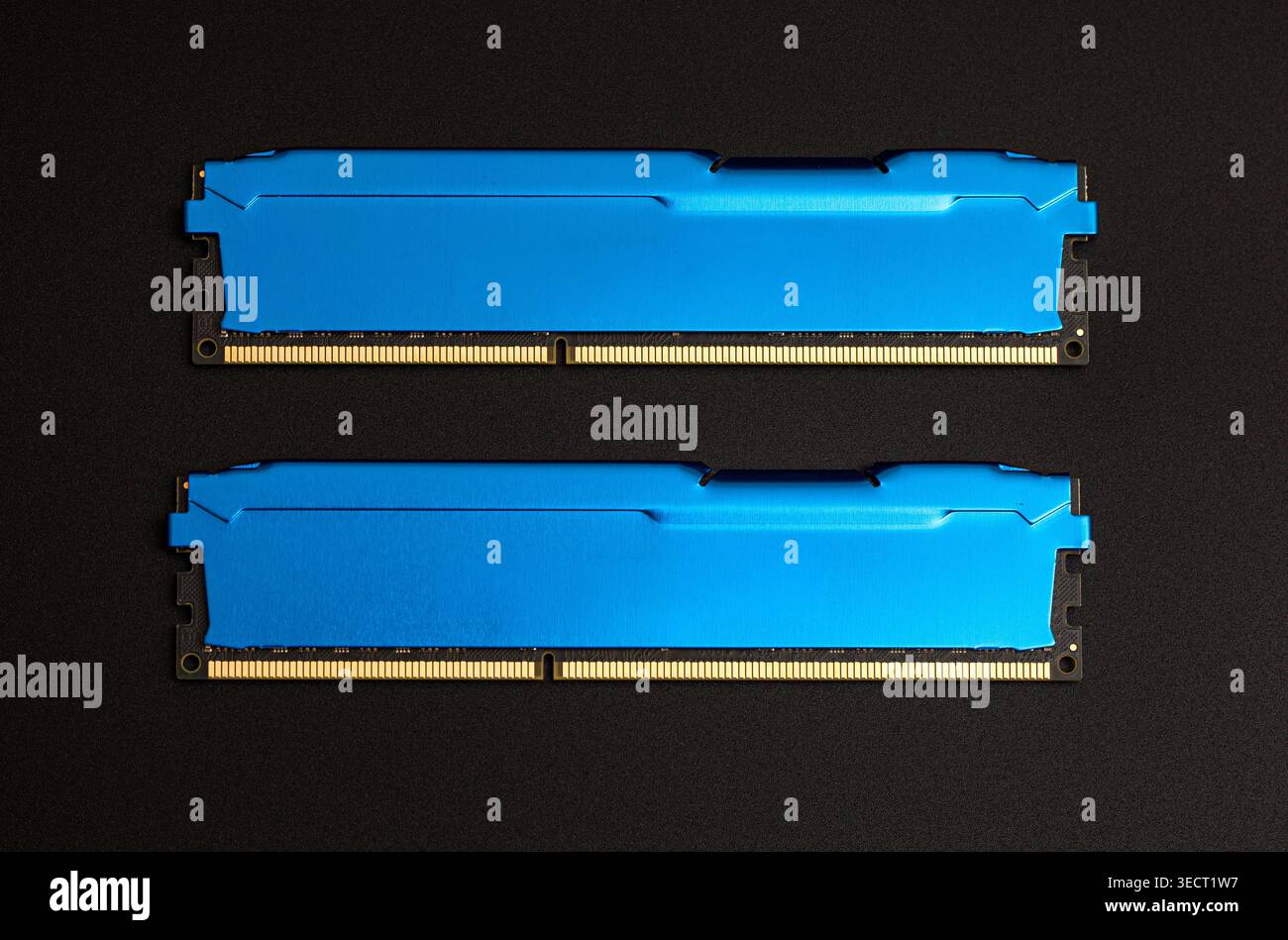 Two blue ram modules laying on a black background, representing computer hardware upgrade Stock Photo