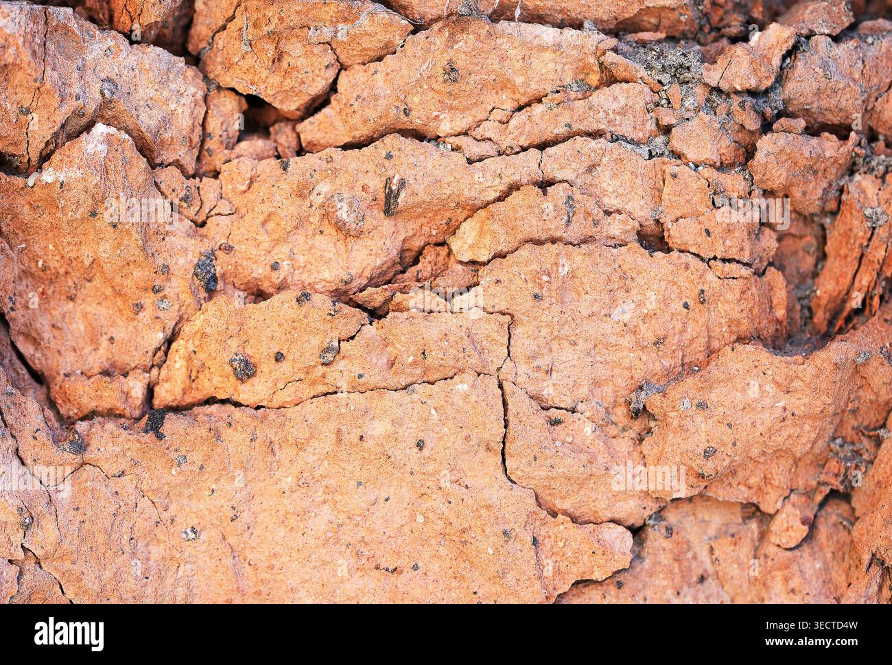 Demaged bricks and stone red orange surface grungy background Stock Photo