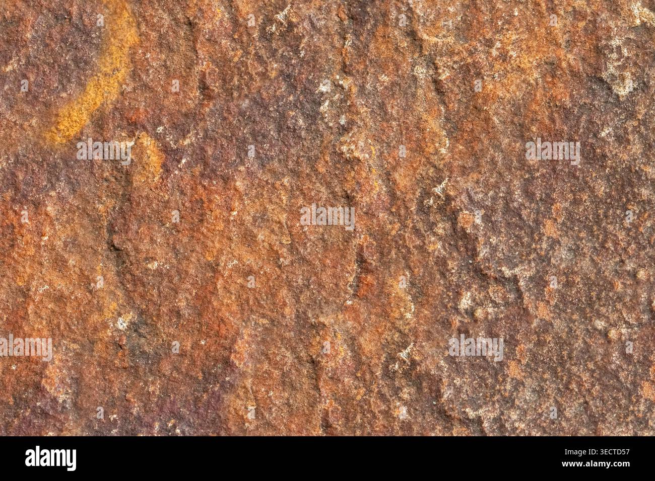 Brown stone rough texture surface with orange inclusions macro Stock Photo