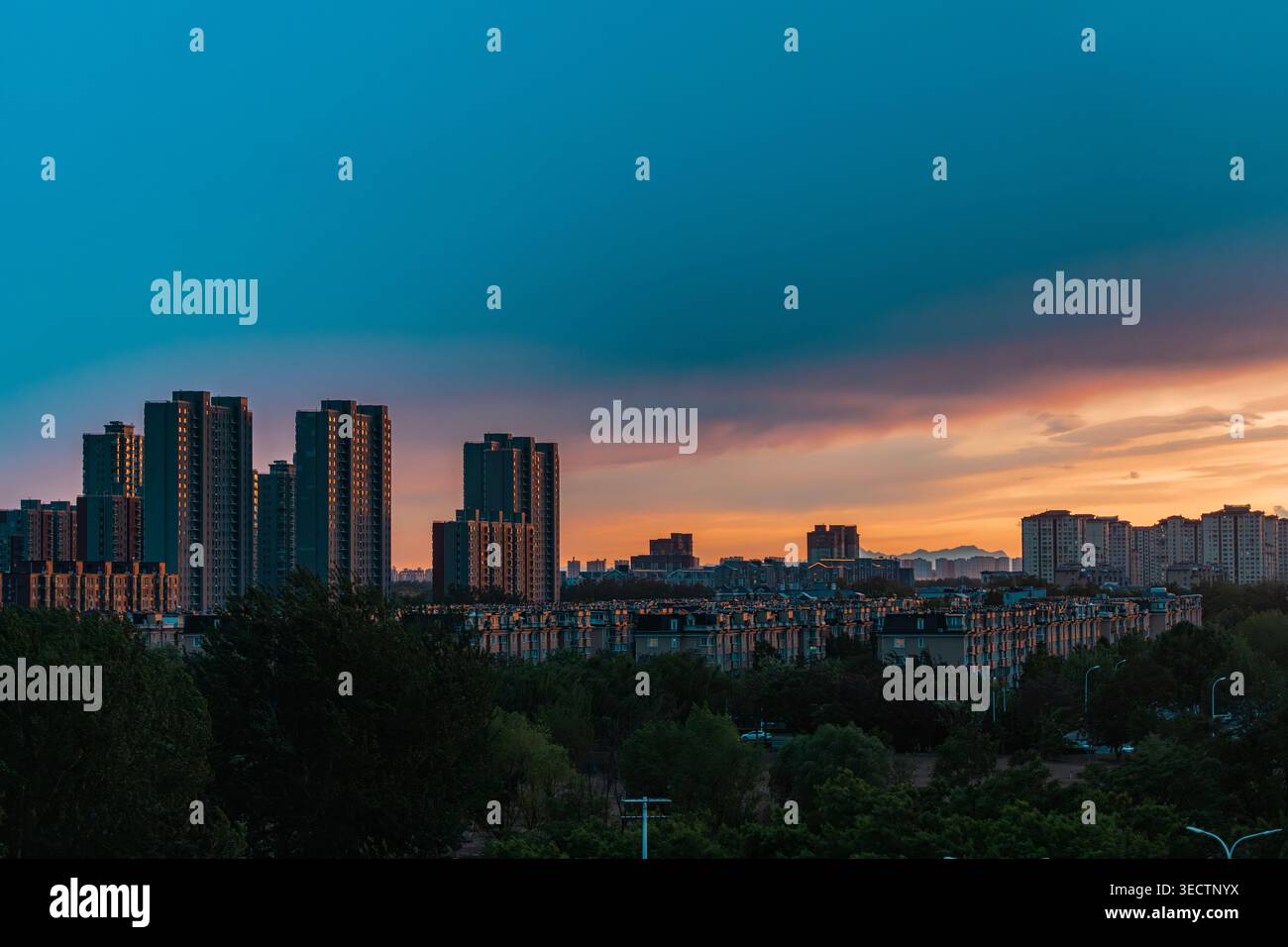 Beijing, China - May 02 2026: Dramatic sunset sky over city skyline and residential high-rise buildings Stock Photo