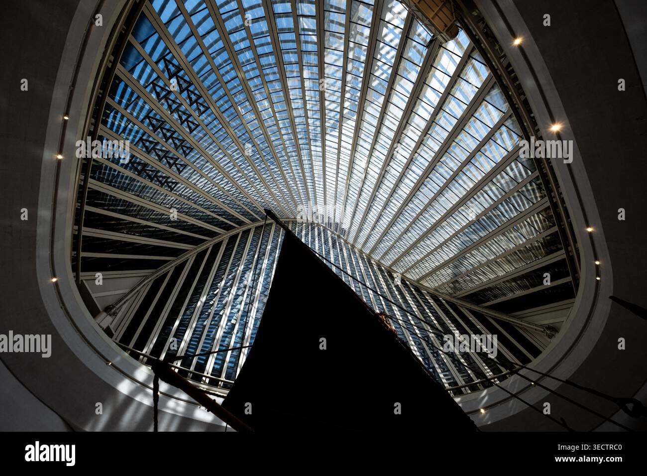 Modern architectural interior with radial glass ceiling structure and ...