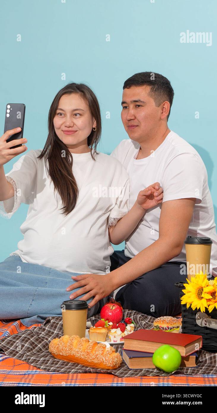 Young couple taking a selfie with a smartphone at picnic Stock Photo