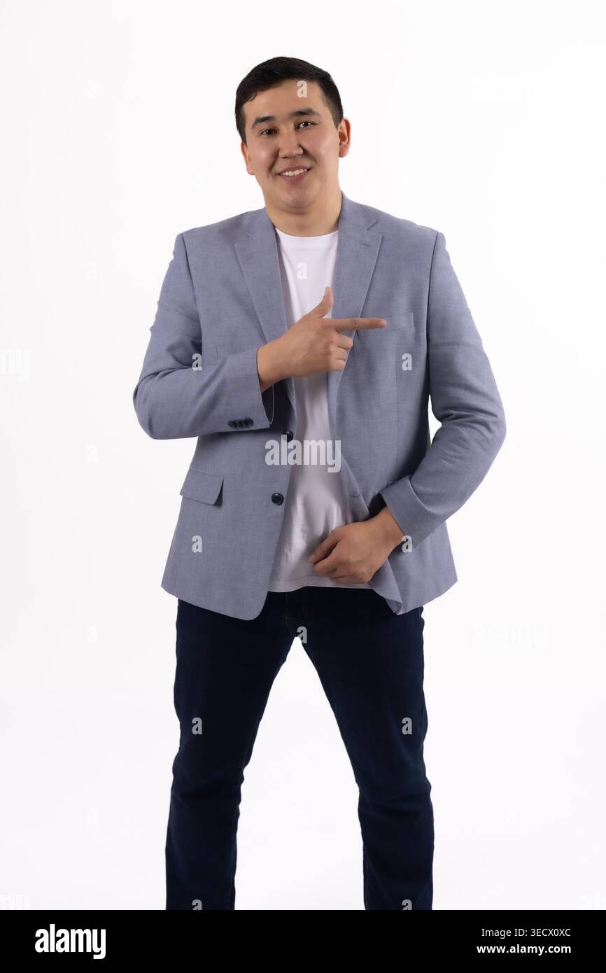 Young man in a blue jacket pointing his finger aside Stock Photo