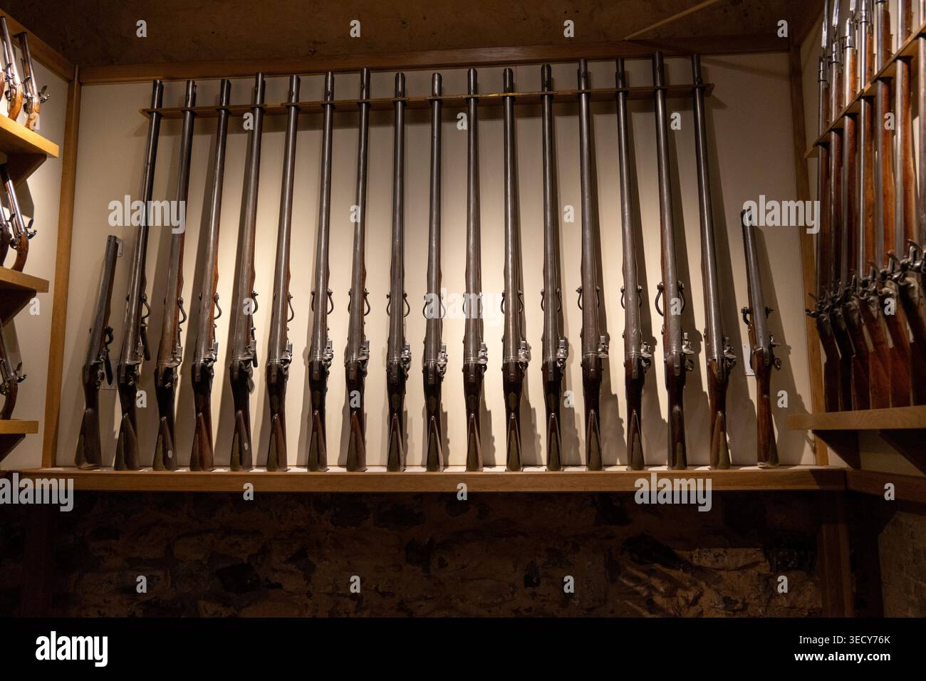 Museum Weapon Rack Wall-mounted rack of historic long guns and flintlock muskets in the ...