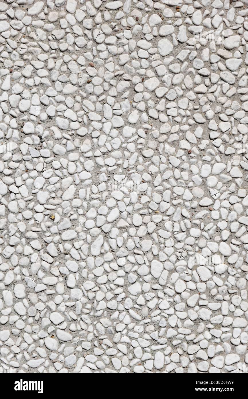 pebbledash roughcast wall background with white pebbles set in cement Stock Photo