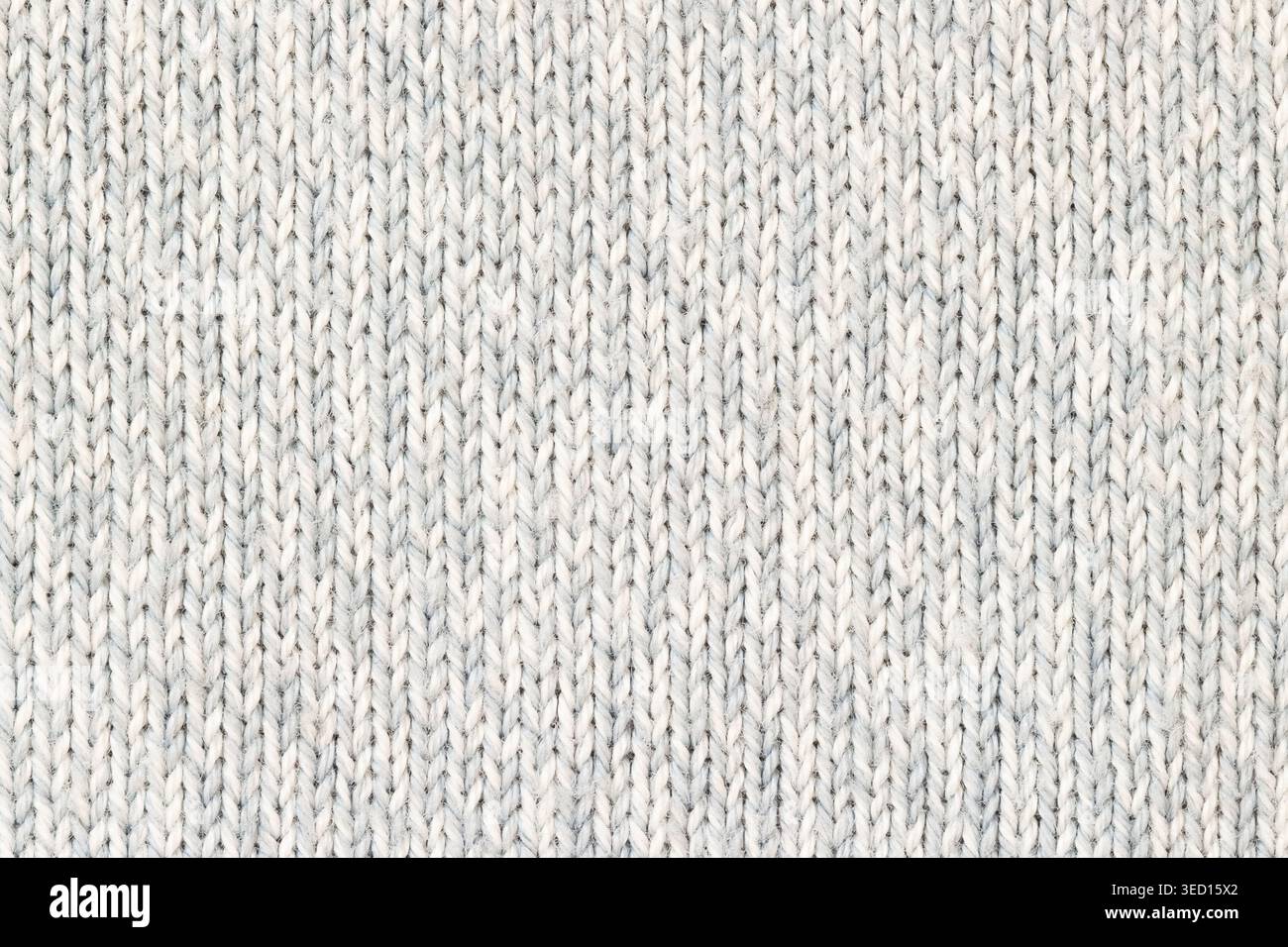 Knitted melange white and blue pattern cotton woolen background macro Stock Photo