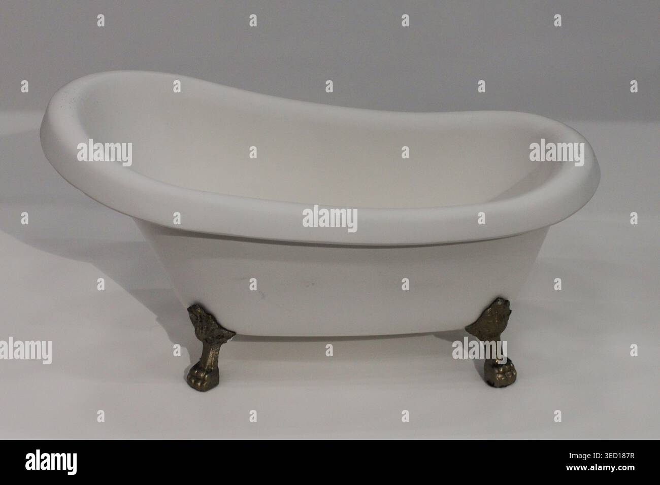 Simple design highlights classic bathroom elegance. Chrome feet contrast softly against smooth porcelain Stock Photo